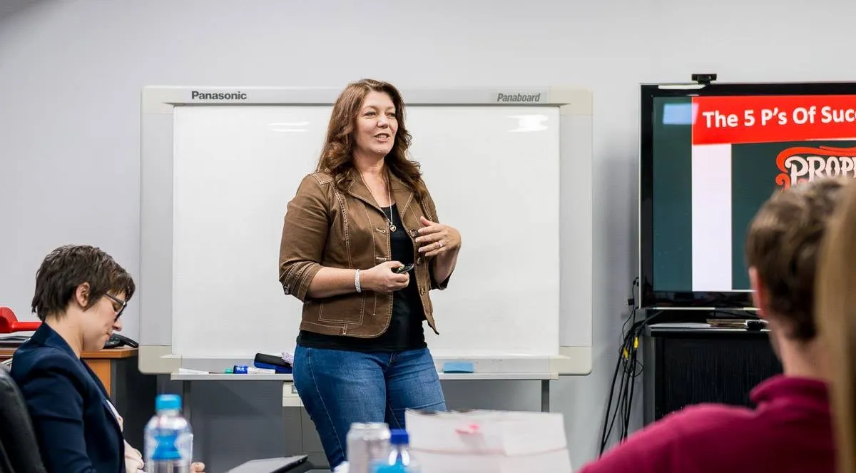 Julie Mason presenting to a room of business professionals